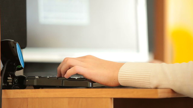 Gamer hand typing on keyboard playing games