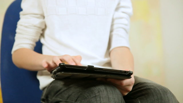 Child playing  games using tablet computer at home