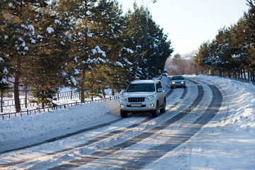 Cars on an ice city winter road