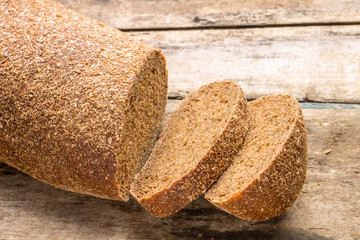 Rye bread laying on the old wood table.
