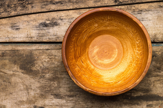 Ceramic bowl on wood background. Top view