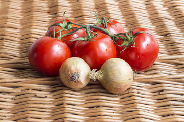 Pomidory i cebula na wiklinowej teksturze © SylaK