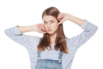 Fototapeta premium Young fashion girl in jeans overalls posing isolated