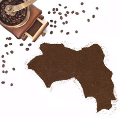 Coffee powder in the shape of Guinea and a coffee mill.(series)
