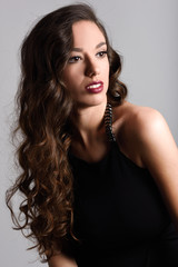 Brunette woman with long hair wearing black t-shirt