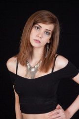 Woman looking thoughtful with her hand on her hip