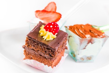 Delicious slice of chocolate cake with cream and candy to sugar
