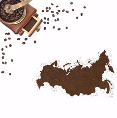 Coffee powder in the shape of Russia and a coffee mill.(series)