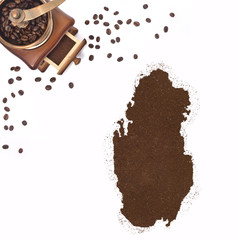 Coffee powder in the shape of Qatar and a coffee mill.(series)