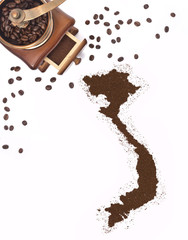 Coffee powder in the shape of Vietnam and a coffee mill.(series)
