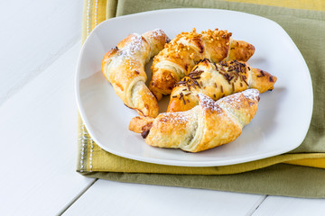mixed croissants in white plate