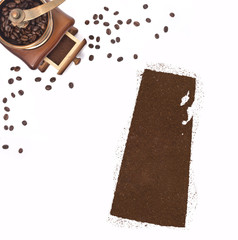 Coffee powder in the shape of Saskatchewan and a coffee mill.(se