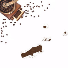 Coffee powder in the shape of Johnston Atoll and a coffee mill.(