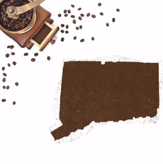 Coffee powder in the shape of Connecticut and a coffee mill.(ser