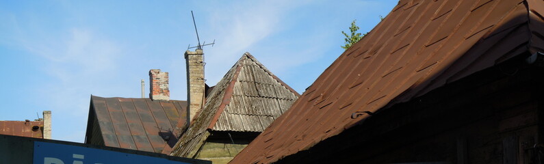 Obraz premium Iron roofs and brick chimneys