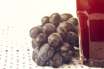 Dark grapes Isolated on white background glass of juice