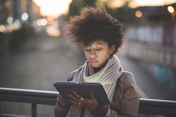 beautiful black curly hair african woman using tablet