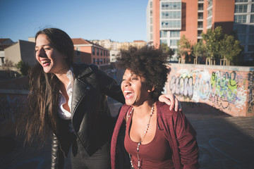 two multiethnic beautiful young woman black and white having fun
