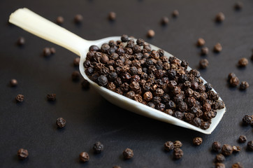 Spoon full of black peppercorn