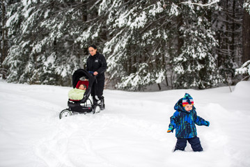 Fototapeta na wymiar Family Walking in Deep Snow at a Park