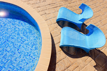 closeup of a pool with sunbeds