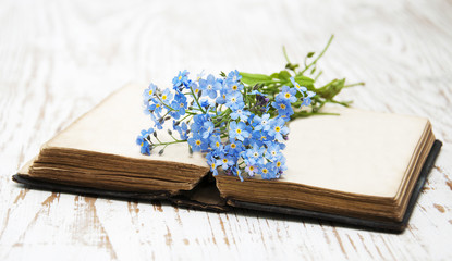 Forget-me-nots flowers and old book