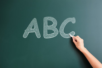 writing ABC  on blackboard