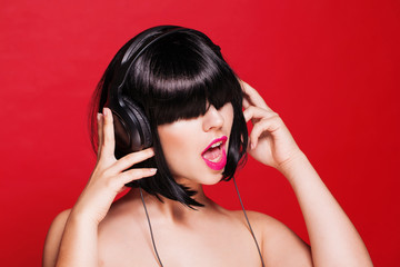 Woman listening to music on headphones enjoying a dance. Closeup