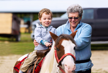First Pony Ride for a Little Boy - 76263599