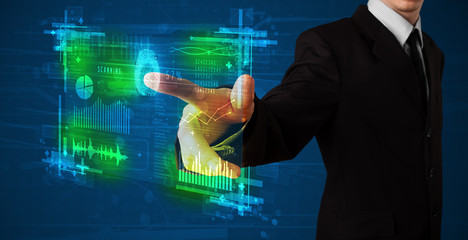 Young businessman pressing modern technology panel with finger p