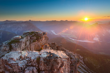 rocky top of mountain in tirol alps at colorful sunset