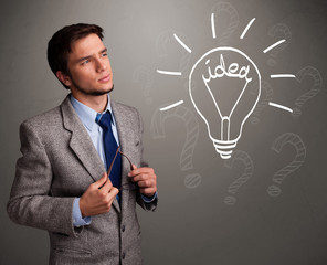 Young boy comming up with a light bulb idea sign