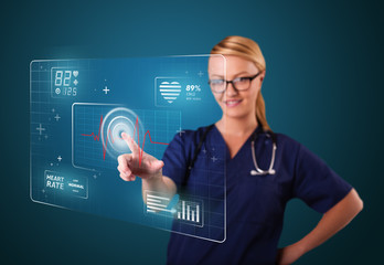 Young nurse pressing modern medical type of buttons