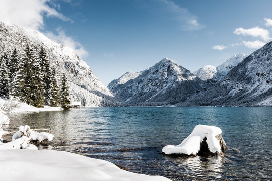 idyllic cold lake at snow mountain landscape in winter scenery