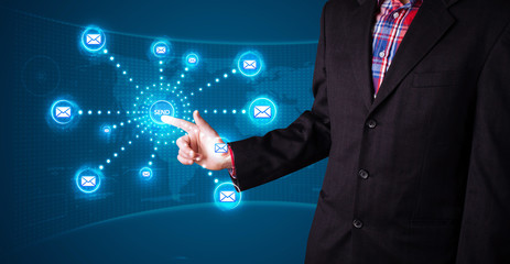 Businessman pressing virtual messaging type of icons