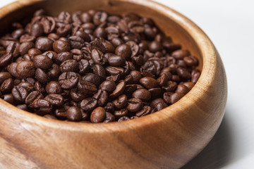 Many coffee beans in wooden bowl
