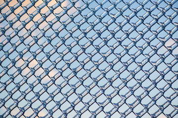 Fototapeta premium Refracted Clouds and Blue Sky Through Ice on Fence