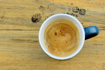 Coffe mug on old wood with text