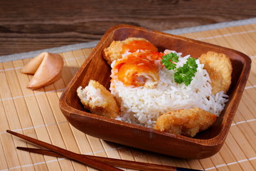 Chicken meat with rice, red sauce on bamboo mat