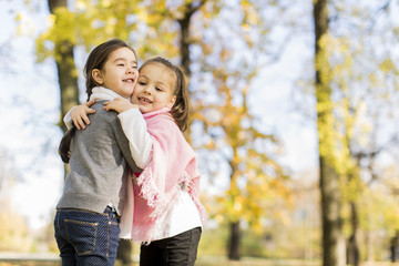 Little girls in the autumn park