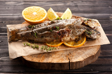 Baked trout fish with orange and thyme