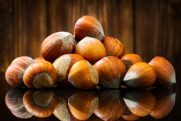 Raw Organic Whole Hazelnuts on wooden background. Selective