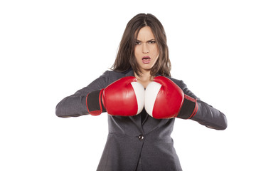 Portrait of angry business woman with boxing gloves