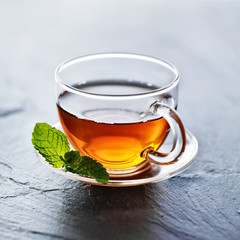 glass of hot tea with mint garnish