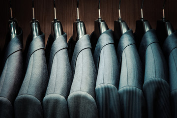 Fototapeta Row of men suit jackets on hangers obraz