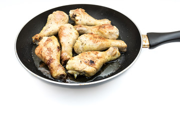 chicken drumsticks in frying pan 
