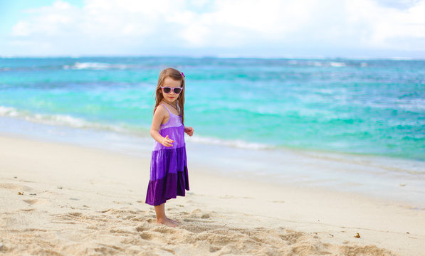 Adorable little girl having fun during tropical vacation