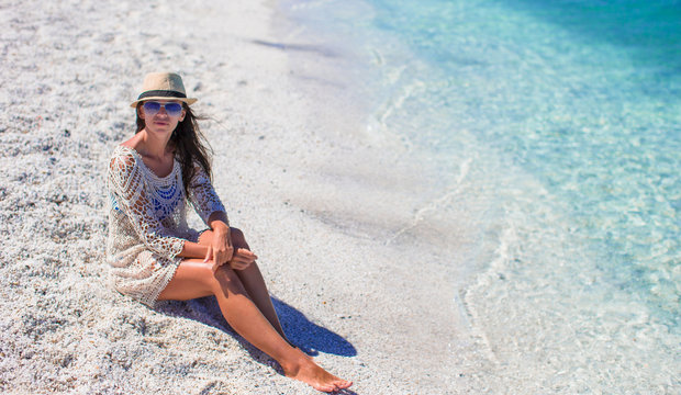 Young beautiful woman enjoying beach tropical vacation
