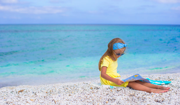 Adorable little girl with map of island on tropical beach