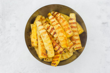 Fried pineapples on plate outdoors on snow